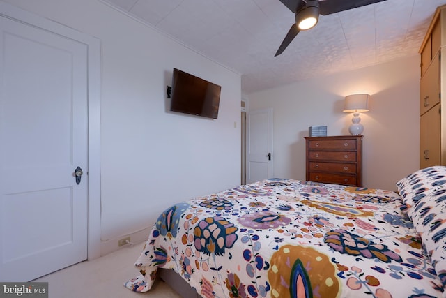 bedroom featuring light carpet and ceiling fan