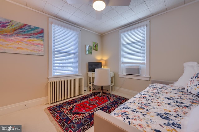 bedroom featuring radiator, cooling unit, and ornamental molding