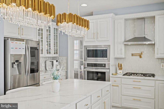 kitchen with white cabinetry, stainless steel appliances, and a chandelier