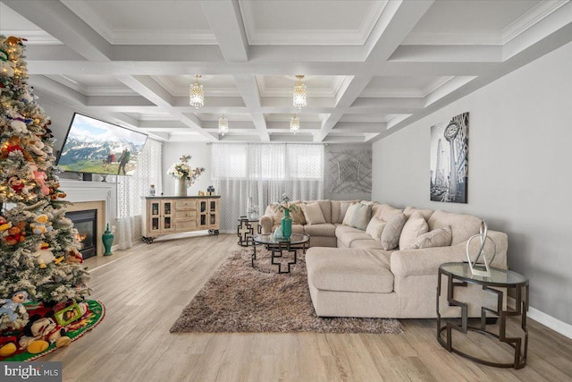 living room featuring beamed ceiling, light hardwood / wood-style floors, crown molding, and coffered ceiling