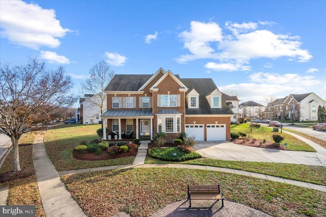 view of front of house featuring covered porch, a garage, and a front lawn