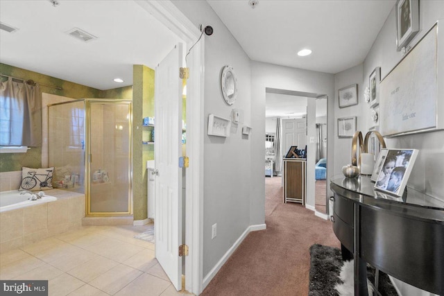 bathroom with separate shower and tub and tile patterned floors