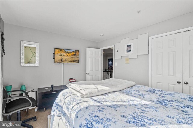 carpeted bedroom with a closet