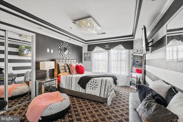 bedroom featuring crown molding, a tray ceiling, and multiple windows