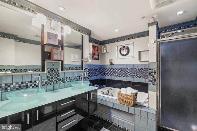 bathroom featuring tile patterned floors, vanity, and shower with separate bathtub