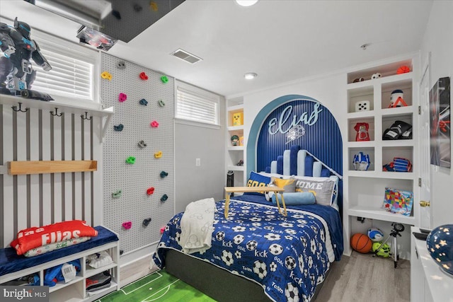 bedroom with wood-type flooring