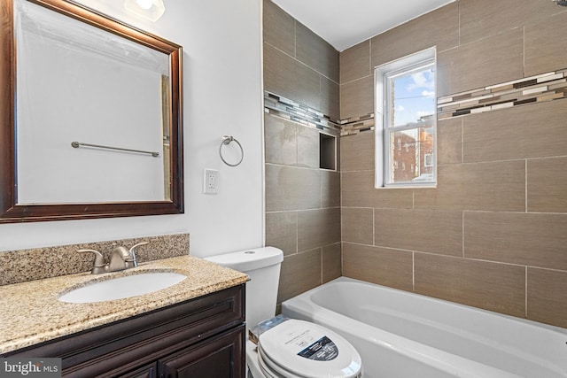 full bathroom featuring vanity, toilet, and tiled shower / bath