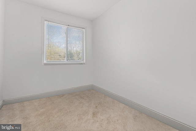 unfurnished room featuring light colored carpet