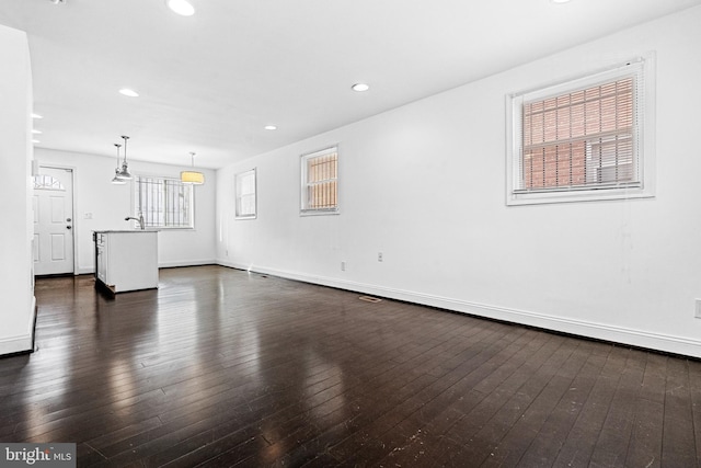 unfurnished living room featuring dark wood-type flooring