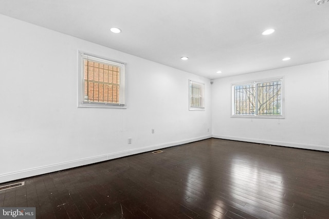 unfurnished room with dark hardwood / wood-style floors