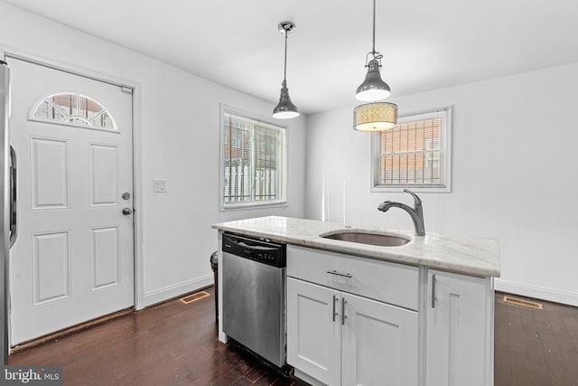 kitchen featuring light stone counters, stainless steel dishwasher, sink, pendant lighting, and white cabinetry