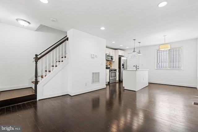 unfurnished living room with dark hardwood / wood-style flooring