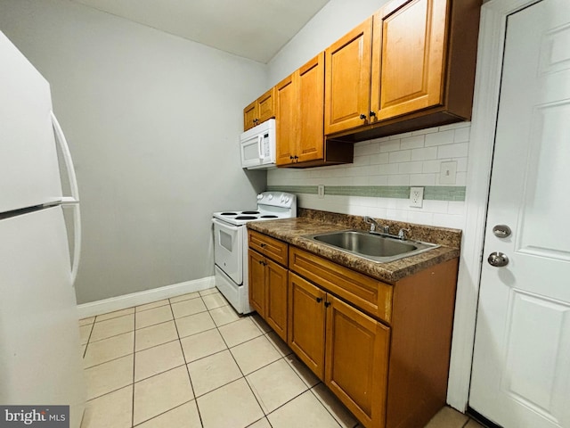 kitchen featuring light tile patterned flooring, white appliances, sink, and tasteful backsplash