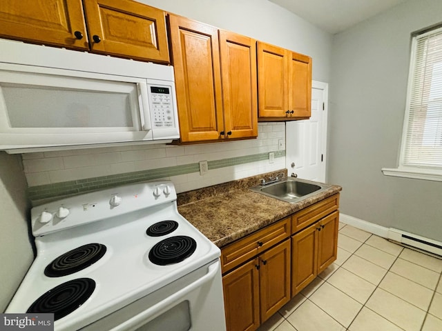 kitchen with decorative backsplash, white appliances, sink, light tile patterned floors, and a baseboard radiator