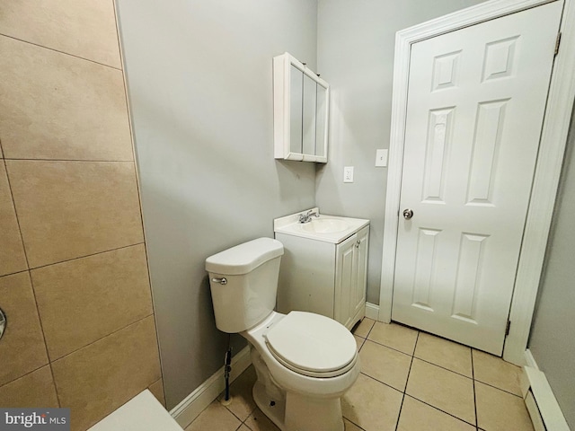 bathroom with tile patterned flooring, vanity, toilet, and a baseboard heating unit