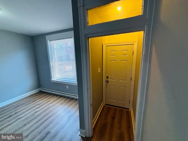 interior space featuring hardwood / wood-style floors and a baseboard heating unit