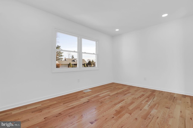 empty room with light hardwood / wood-style floors