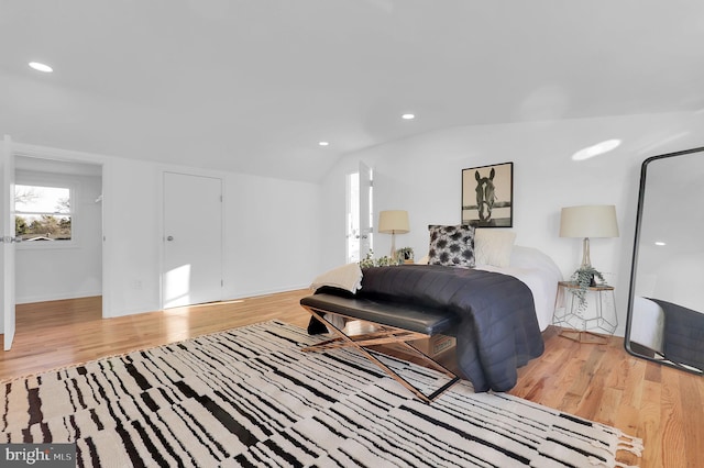 living room with lofted ceiling and light hardwood / wood-style flooring