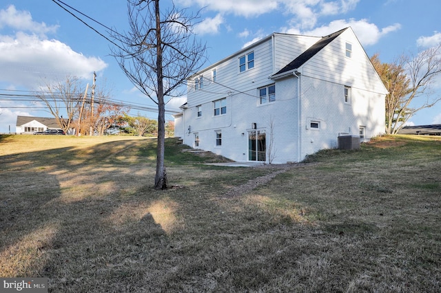 view of side of property with a yard and cooling unit