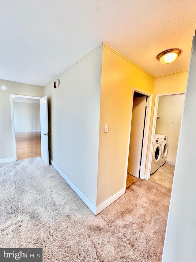 interior space with crown molding, a textured ceiling, and independent washer and dryer