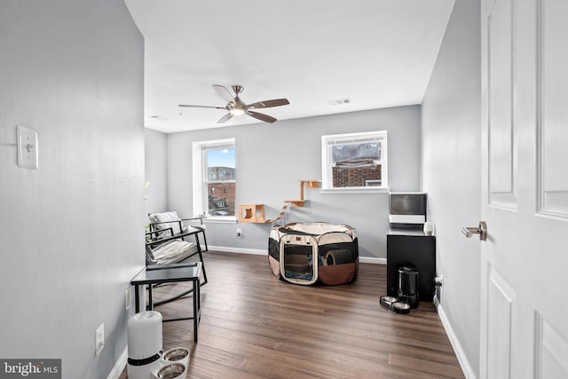 sitting room featuring dark hardwood / wood-style flooring and ceiling fan