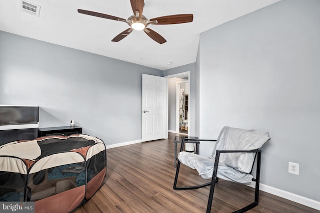 interior space featuring ceiling fan and dark hardwood / wood-style flooring