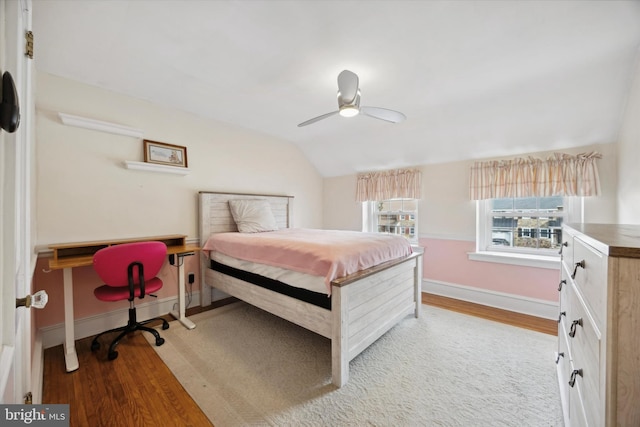 bedroom featuring ceiling fan, light wood-type flooring, and vaulted ceiling