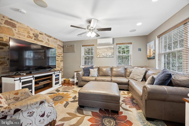 living room with light hardwood / wood-style flooring, a wall mounted AC, and ceiling fan