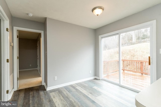 empty room with hardwood / wood-style flooring