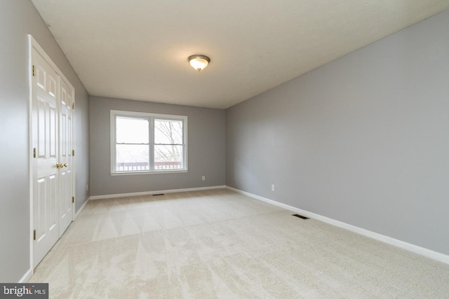 spare room with light colored carpet