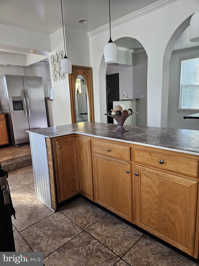 kitchen featuring dark tile patterned flooring, decorative light fixtures, stainless steel fridge with ice dispenser, and crown molding