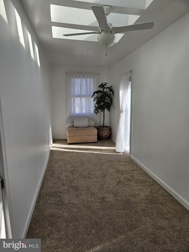 carpeted spare room featuring ceiling fan