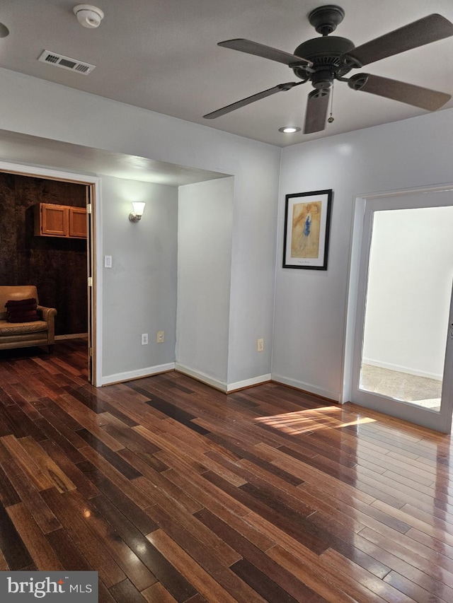 spare room with ceiling fan and dark hardwood / wood-style flooring