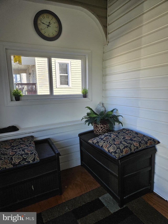 exterior space with wooden walls and dark wood-type flooring