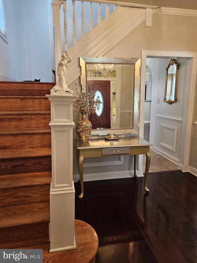 interior space featuring wood-type flooring and crown molding