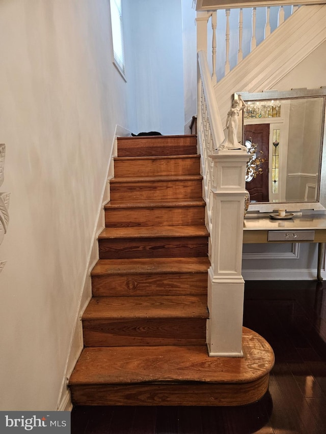 stairway featuring hardwood / wood-style floors