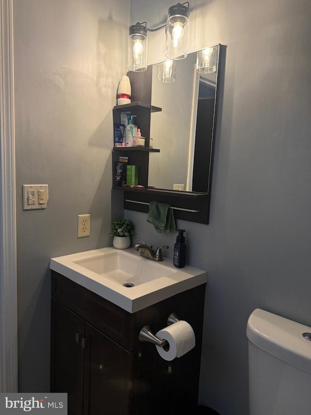 bathroom featuring vanity and toilet