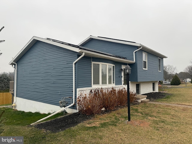 view of property exterior featuring a lawn