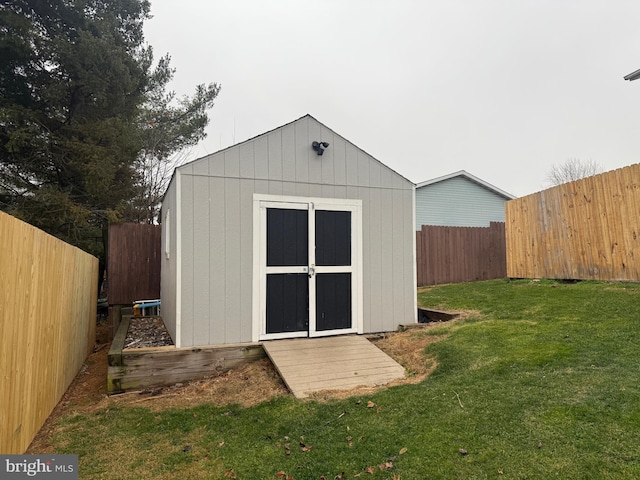 view of outbuilding featuring a yard