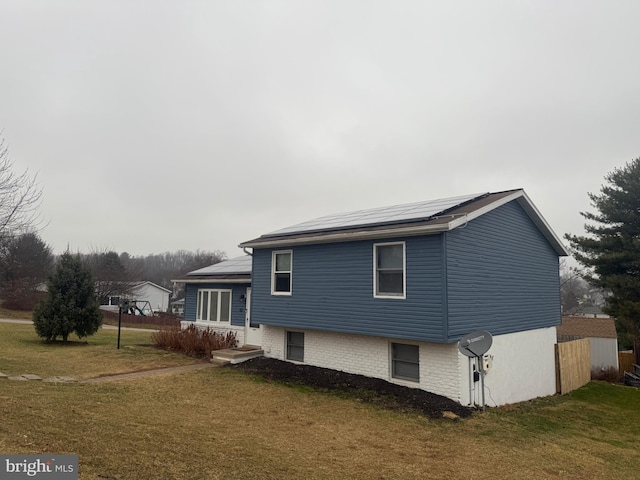 exterior space with a lawn and solar panels