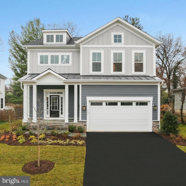 craftsman inspired home with a garage and a front lawn