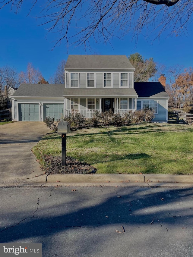 view of front of home with a garage and a front lawn