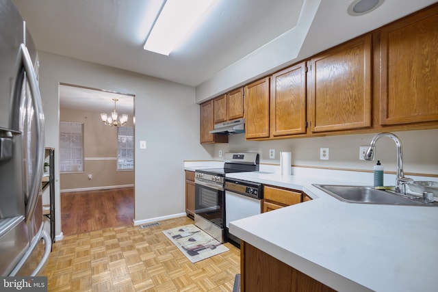 kitchen featuring sink, hanging light fixtures, stainless steel appliances, a notable chandelier, and light parquet flooring