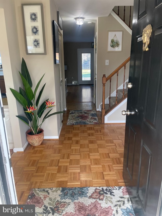 foyer entrance with light parquet flooring