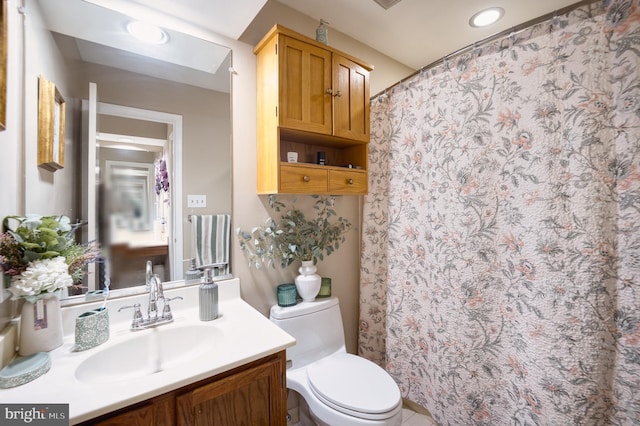 bathroom featuring vanity and toilet