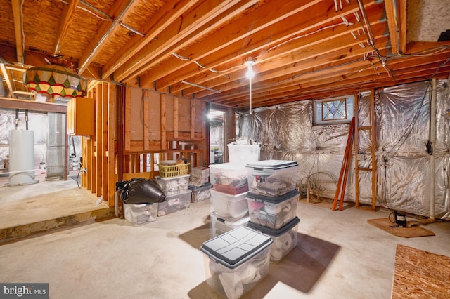 basement featuring a wealth of natural light and water heater