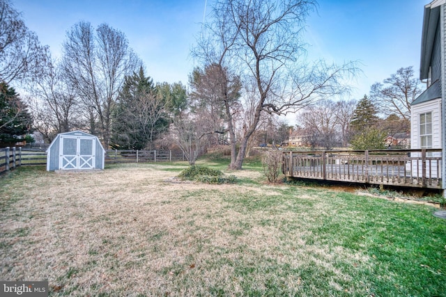 view of yard featuring a storage shed and a wooden deck