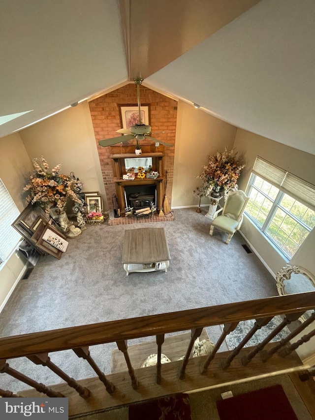 unfurnished living room featuring vaulted ceiling with beams and carpet floors