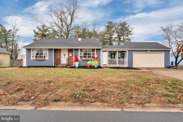 single story home featuring a garage and a front lawn