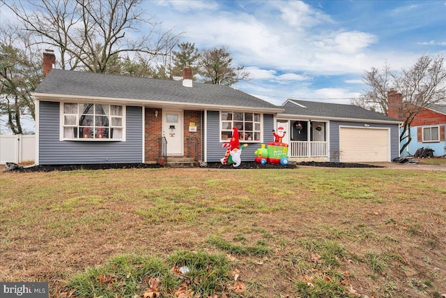 ranch-style home with a front lawn and a garage